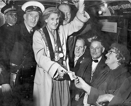 Mrs Violet Ayres, Mayor of West Ham, issues a ticket on the last trolleybus in West Ham. April 1960.
