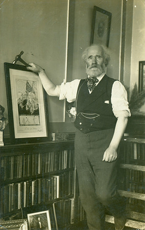 Keir Hardie hanging a picture.