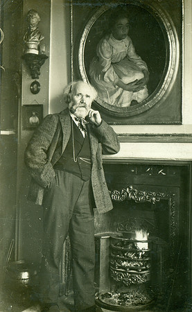 Keir Hardie by fireplace.