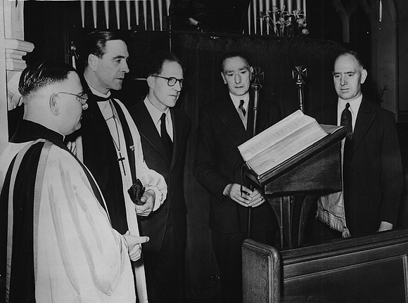 Christ Church, High Street, Stratford. Hugh Gough, Bishop of Barking, at the new lectern bible dedicated to the memory of Canon R Bertin, former vicar of Christ Church. 19 May 1952