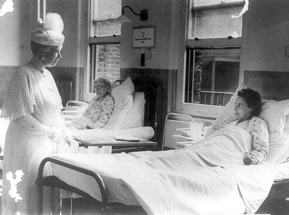 Queen Mary talking to a patient during a visit to Queen Mary's Hospital, West Ham Lane, Stratford. 1945.